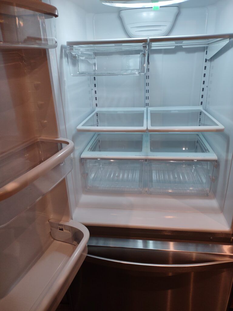 Clean, empty fridge shelves and drawers