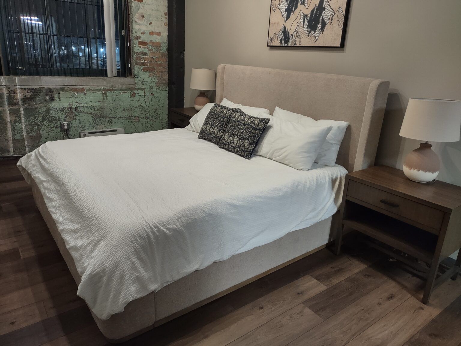 Freshly made bed with crisp white linens in a clean bedroom