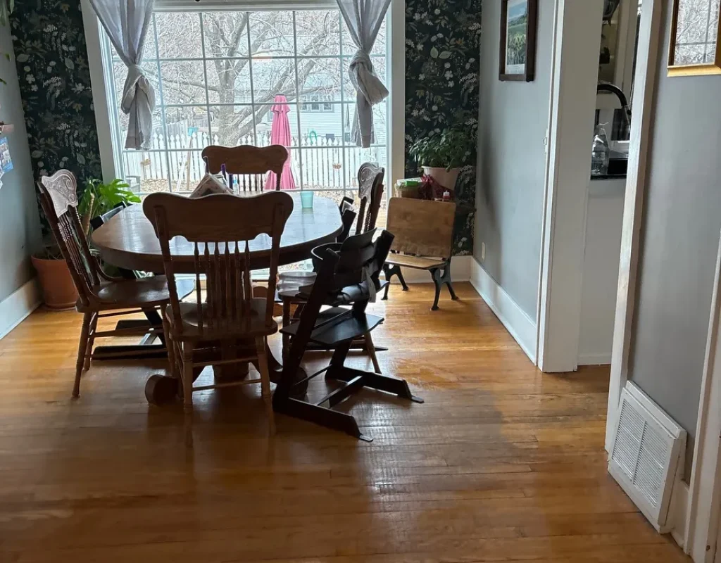 Cleaner wiping dusty baseboards and a door frame in a Springfield, NE empty home.