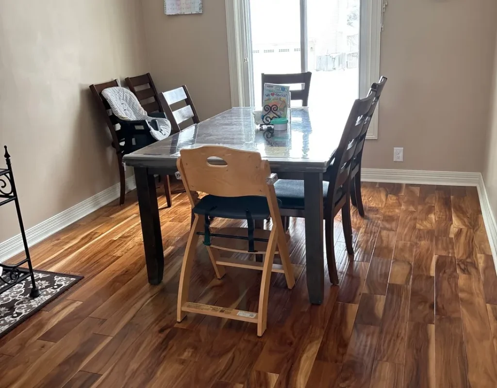 Clean dining area with a table, chairs, and wood floor, prepared during a move out cleaning in Ralston, NE.