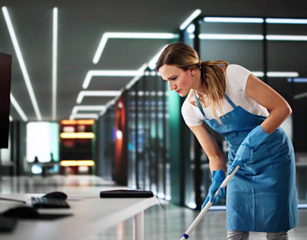 Reliable cleaning team dusting furniture and surfaces to maintain fresh interiors.